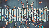 Aerial. People crowd on pedestrian crosswalk. Top view background. Toned image.